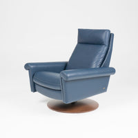 A blue leather Nimbus recliner chair with a disc base in Natural Walnut. Front and side view.
