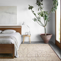 Odyssey Natural + Ash Area Rug placed in a bedroom.