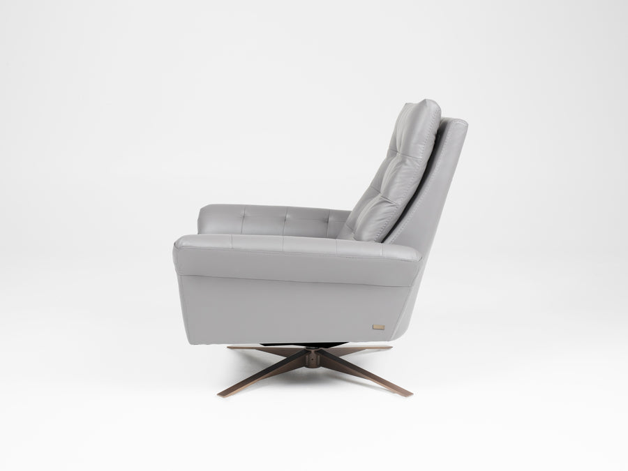 A grey leather recliner chair with buttonless tufted back and seat and four star base, side view.