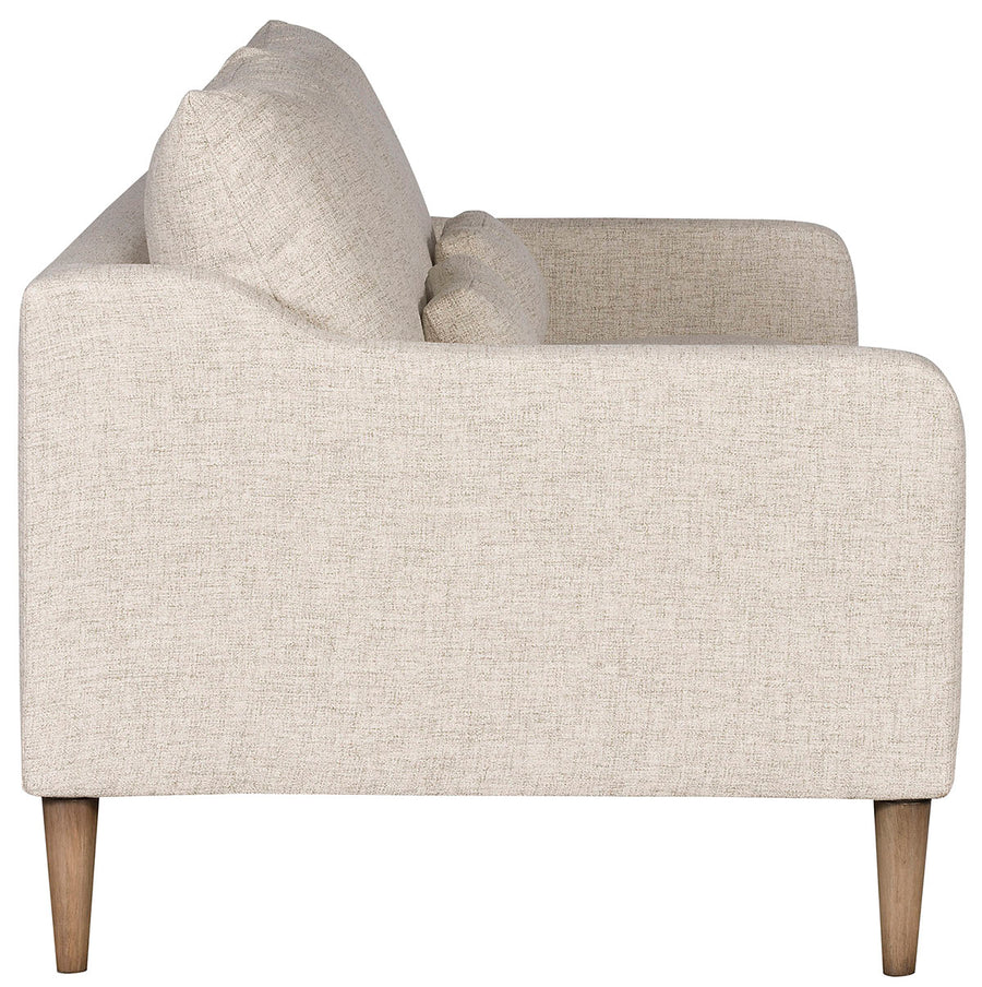 Thea Stocked two seat sofa with medium firm seat and back done in a feather blend cushion with lower arm that is shaped from back to front. Side view.