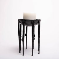 Black Medieval-inspired iron candleholder.