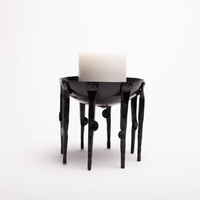 Black Medieval-inspired iron candleholder.