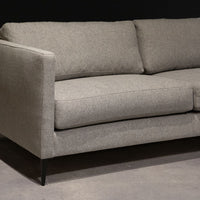 Grey two seat Benedict sofa with clean lines and sleek metal legs. Front view.