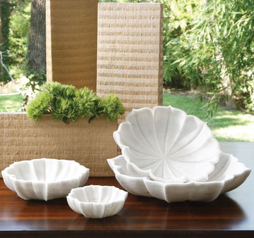 Marble Petal four Bowl Collection formed in snow white honed marble and pieces carved into petal-like shapes.