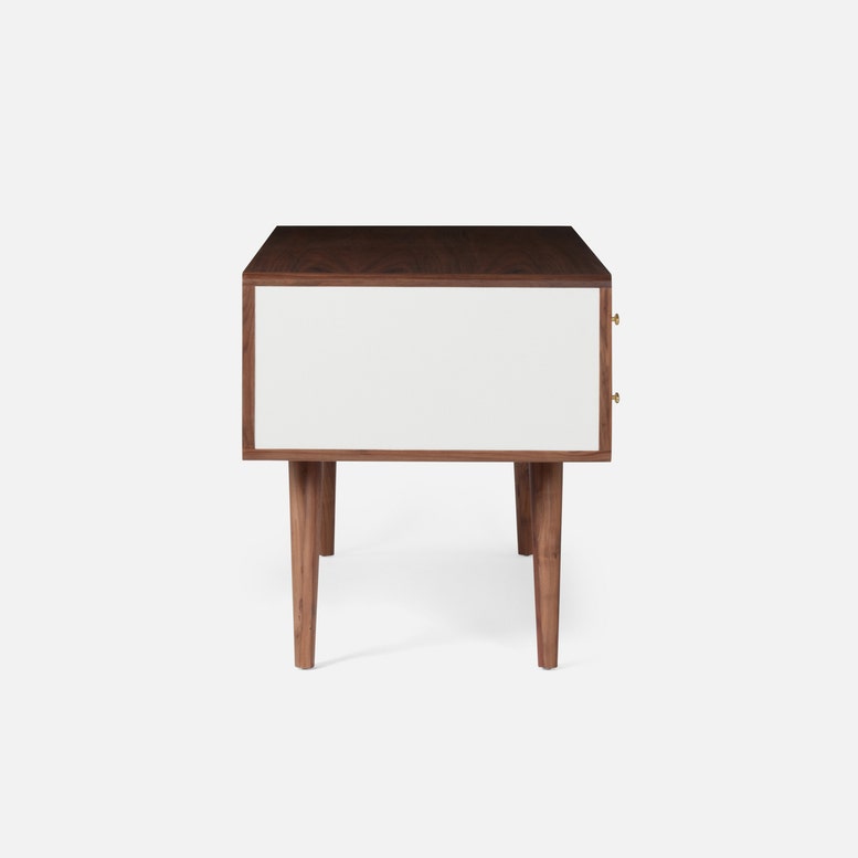 Delmira Desk with four drawers covered in dove white faux canvas and spacious top, cabinet, and angled tapered legs, all hand-crafted from the highest quality stained walnut. Side view.