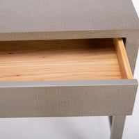 Conrad Desk with clean and simple design, finished in “seal” colored faux raffia, and with two flush drawers. Closed up view of an open drawer.