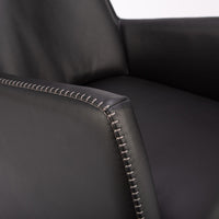 A black leather Kate swivel armchair. Closed up side view.