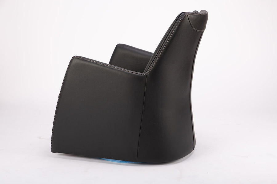 A black leather Kate swivel armchair. Side view.