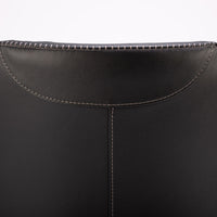 A black leather Kate swivel armchair. Closed up back view.