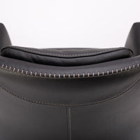 A black leather Kate swivel armchair. Closed up back view.