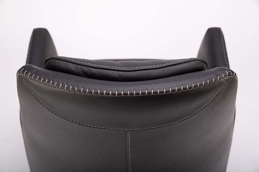 A black leather Kate swivel armchair. Closed up back view.