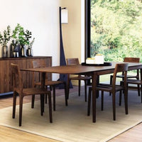 Lise buffet cabinet placed in a dining room with vases on it.