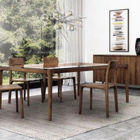 A set of Lisse dining chairs around a dining table, placed in a modern dining room.