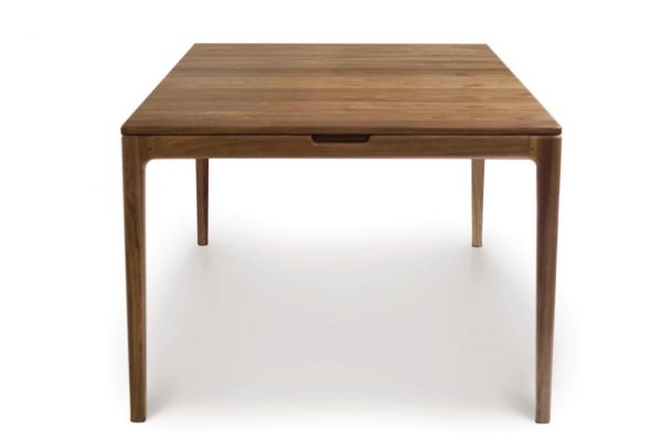 Lisse Extension dining table crafted in solid American black walnut hardwood with natural finish and with a single self-storing butterfly leaf for single handed operation. Side view.