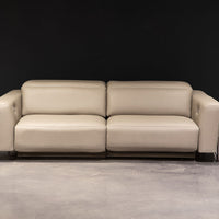 White leather two seat Turin sofa with splayed metal legs and power mechanism that operates the headrest and footrest independently