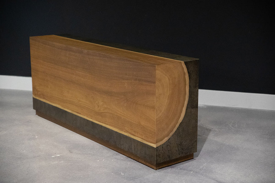Yuka wood Kobe console with the anodized metal panels and toasted finish, side front view.