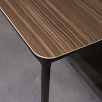 Slim Dining Table with die cast aluminum legs and wooden top. Closed up view on top surface.