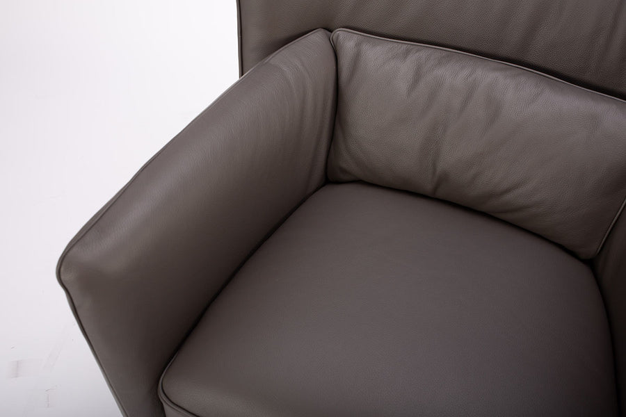 Dark brown leather Tulip swivel armchair, endowed with a lower-back cushion. Closed up top view.