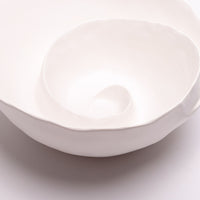 Spiral Bowl made of Portuguese ceramic with an matte white finish and a swirling ridge that spirals from the outer edges of the bowl towards the center.