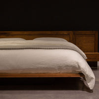 King size Moduluxe bed with modular headboard and nightstands with a floating look in wood colors, front view.