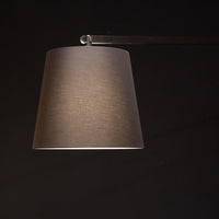 Cloe contemporary Floor Lamp in aged brass, with frame and base in lacquered metal and adjustable arm in lacquered aluminum. Closedup view on the lamp.