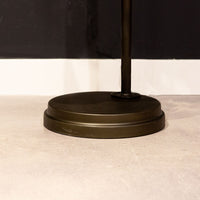 Black Babylon Floor Lamp with formed of bold concentric circles and with floor switch on cord. Closed up view on floor part.