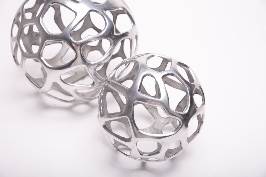 A big and a small Ennis Web Whimsical Spheres made from antique silver.