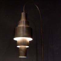 Black Babylon Floor Lamp with formed of bold concentric circles and with floor switch on cord. Closed up view on lamp.