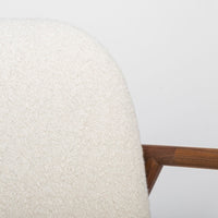 A white Lex lounge chair with solid maple frame, curved back. Closed up top view.