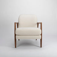 A white Lex lounge chair with solid maple frame, curved back. Front view.
