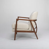 A white Lex lounge chair with solid maple frame, curved back. Side view.