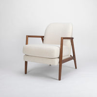 A white Lex lounge chair with solid maple frame, curved back. Front and side view.