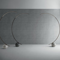 Three elliptical modern Circle metal floor lamp done in dark brass with concrete ball base.