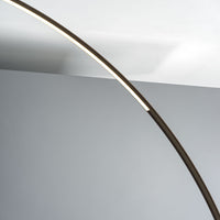 Elliptical modern Circle metal floor lamp done in dark brass with concrete ball base. Closed up view on lamp.