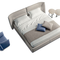 Tulip Leather-upholstered King Size bed in light colors, with bedside tables and a blue chair, a view from above.