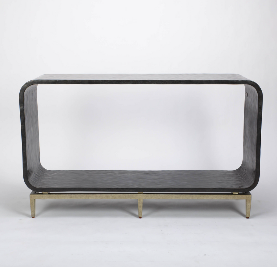 Wilhelm console that offers texture in the graphite gesso material, curvature for framing and a classic metal base to feature the unique design.