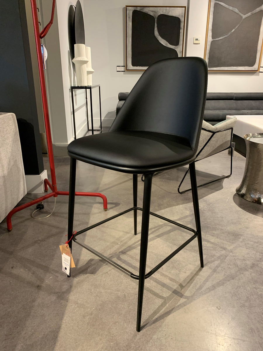 Black Lea counter stool with four-legs metal base and seat and backrest upholstered in hide.
