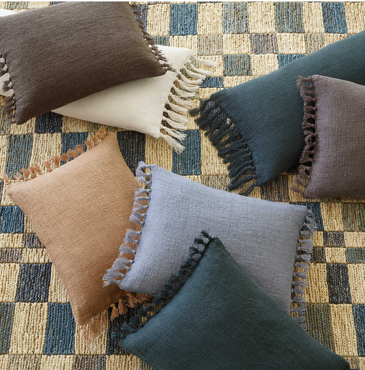 Seven Evelyn Decorative Lumar Pillows in different colors and sizes.