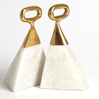 Pyramid shaped Equestrian Marble Bookends with white marble bases topped with a brushed brass stirrup detail.