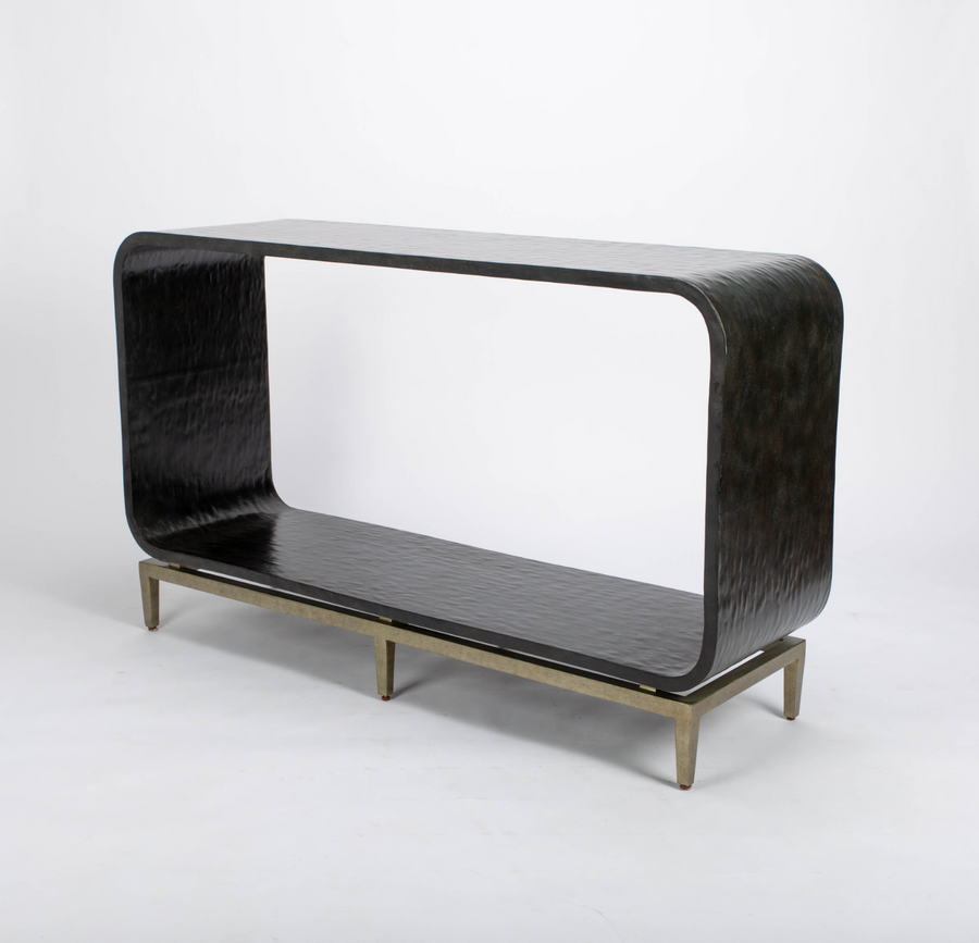 Wilhelm console that offers texture in the graphite gesso material, curvature for framing and a classic metal base to feature the unique design. 