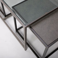 Metal nesting cocktail table consisting of glass top center table and 2 outer bunching tables, slide under the ends of the center table