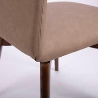 A beige Hexa swivel dining chair with wood base. Closed up back and side view.