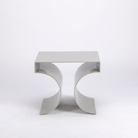 Kinkou Far East accent designer table done in silver metal with contemporary artful design. Front view. 