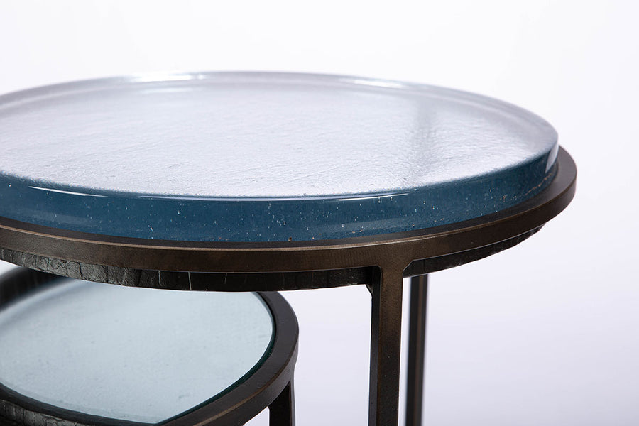 Carolina Nesting two side tables with glass top and hand forged steel. Closed up view of the top of the large table.