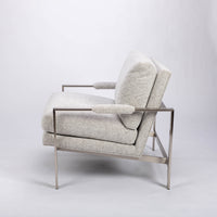 951 lounge chair in light colors with slender rectangular steel frame, luxurious blend down seating and upholstery wrapped arm rests, left side view.