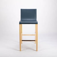 Tosca Barstool with blue leather seating and solid beechwood construction. Front view.
