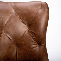 Goodman brown leather chair with curved back, textured woven fabric outside back. Closed up inside cover view.