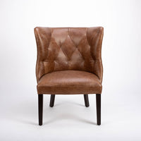 Goodman brown leather chair with curved back, textured woven fabric outside back. Front view.