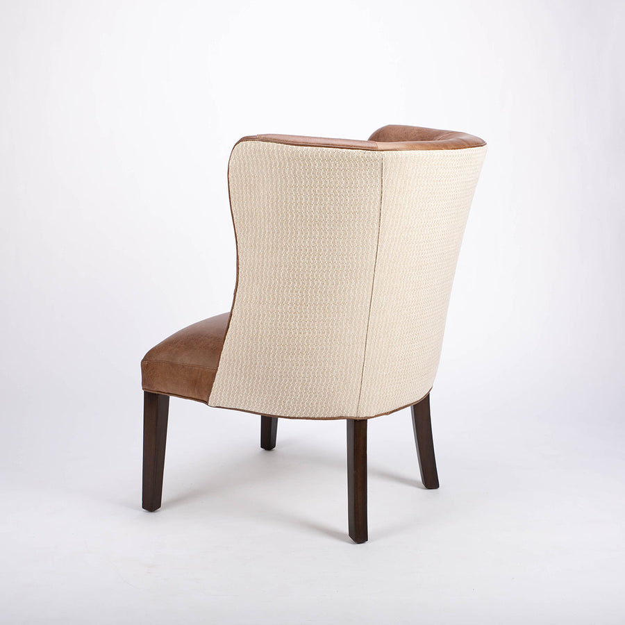 Goodman brown leather chair with curved back, textured woven fabric outside back. Side and back view.