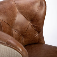 Goodman brown leather chair with curved back, textured woven fabric outside back. Closed up front view.
